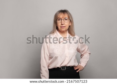 Attractive senior businesswoman wearing glasses head shot