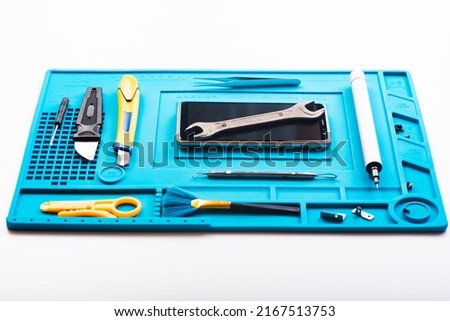 Flat lay image of dismantling the broken smart phone for preparing to repair or replace some components. repairing a damaged mobile phone. Smartphone Repair Tools. Top view