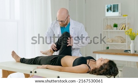 The Physical Therapist Evaluates the Condition and Suggests Appropriate Treatment to Relieve the Patient's Pain. Physiotherapy Treatment in the Modern Rehabilitation Clinic Royalty-Free Stock Photo #2167530061