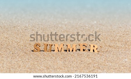 Summer inscription from wooden letters on natural background of sandy beach. Summer vacation, holidays, travel concept. Banner, copy space