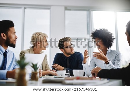 I need everyone to give me their best ideas. Shot of a group of businesspeople sitting together in a meeting. Royalty-Free Stock Photo #2167546301