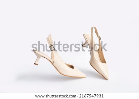 Beige short heels isolated on white background. Fashion concept, catwalk. A modern and trendy shoe store. Royalty-Free Stock Photo #2167547931