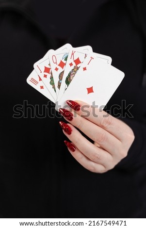 Female hands hold a deck of cards and show tricks.
The photographer is the author of the design of playing cards, which is written in the release of the property.