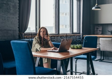 Woman at home sits at her desk with laptop