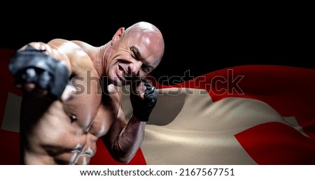 Caucasian male boxer against waving switzerland flag with copy space on black background. switzerland patriotism and sport concept