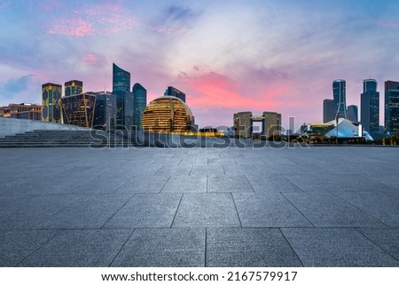 Empty square floor and city skyline with modern commercial buildings in Hangzhou at sunset, China. Royalty-Free Stock Photo #2167579917