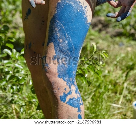 The painter stained his bare legs with paint. Safety precautions Royalty-Free Stock Photo #2167596981