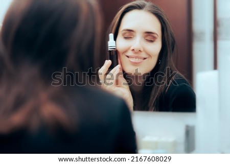 
Woman Using Face Serum During Nighttime Skin Routine. Happy lady with mature complexion applying cosmetic product
 Royalty-Free Stock Photo #2167608029
