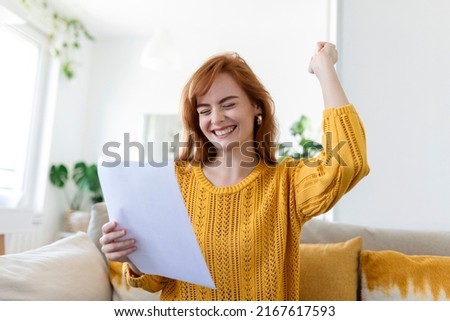 Excited young woman hold paper letter feel euphoric receiving job promotion or tax refund from bank, happy woman reading paperwork document smiling of good pleasant news, getting student scholarship Royalty-Free Stock Photo #2167617593