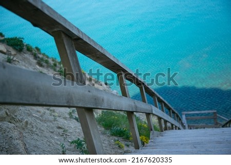 Wooden staircase leading from the mountains to the sea. Paradise place for tourism and recreation. Hiking.