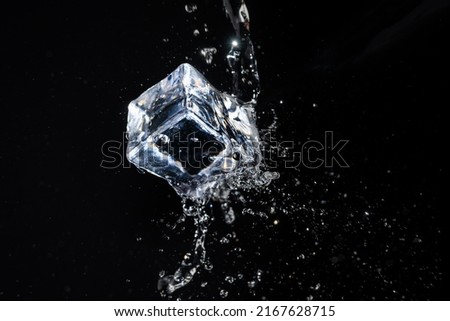 ice cube in water jet on black background Royalty-Free Stock Photo #2167628715