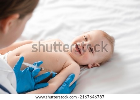 Doctor vaccinating baby in clinic. Little baby get an injection. Pediatrician vaccinating newborn baby. Vaccine for infant child. Child's Immunization, Children Vaccination, Health concept. Alaskapox Royalty-Free Stock Photo #2167646787