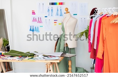 fashion design studio for sewing and cutting clothes, designer clothes, manufacturing, craft product. Royalty-Free Stock Photo #2167652517