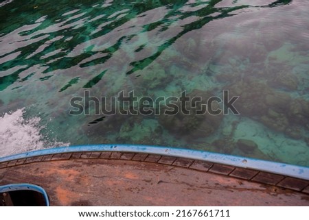 Live on boat take a photo top view see underwater and wooden boat in Lipe Island Thailand.