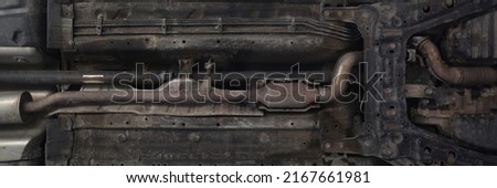 Car lifted in maintenance service to check availability undercarriage of automobile Royalty-Free Stock Photo #2167661981