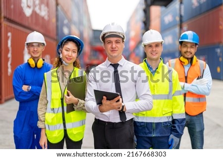 Group portrait of professional working team standing at container yard warehouse. Container yard warehouse, Cargo Shipping Import and Export industry. Logistic shipping yard business. Royalty-Free Stock Photo #2167668303