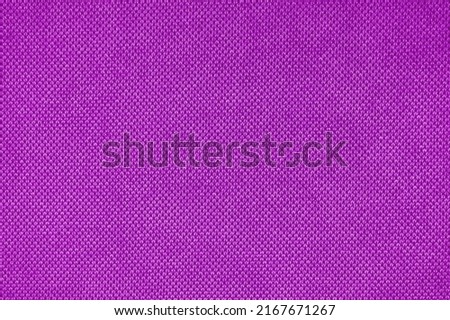 Texture background of velours purple fabric. Fabric texture of upholstery furniture textile material, design interior, wall decor. Fabric texture close up, backdrop, wallpaper.