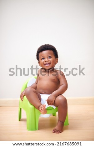 Ive got this potty training thing down. Shot of an adorable baby boy sitting on a potty training seat. Royalty-Free Stock Photo #2167685091