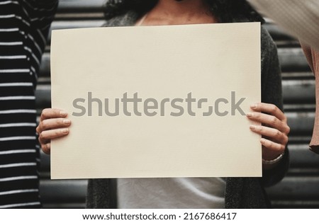 Its a cause worth fighting for. Cropped shot of an unrecognizable woman holding a sign while taking part in a political rally.