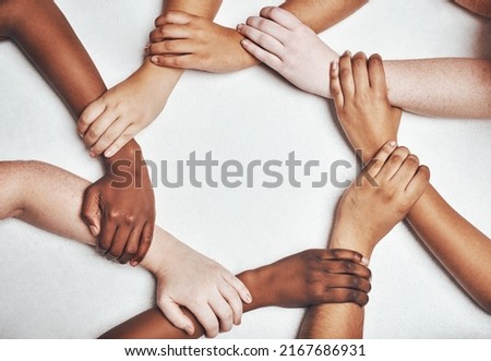 Your circle should be what motivates you. Shot of a group of hands holding on to each other against a white background.