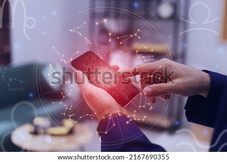 Man with smartphone reading daily horoscope indoors, closeup Royalty-Free Stock Photo #2167690355