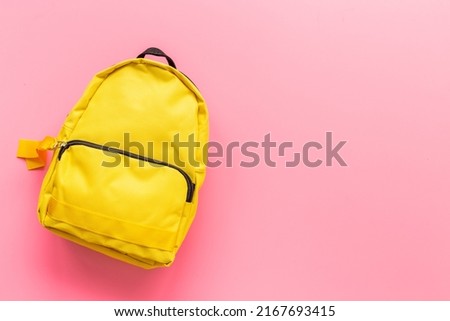 Yellow classic school bag, top view. Back to school concept