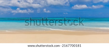 Closeup sand beach sea waves and blue summer sky. Panoramic beach landscape. Empty tropical beach and seascape, horizon. Bright exotic coast calmness, tranquil seaside nature view relaxing sunlight Royalty-Free Stock Photo #2167700181