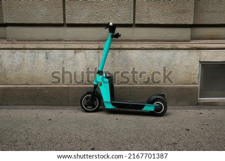 A picture of electronic kickscooter parking at the wall in Zurich City