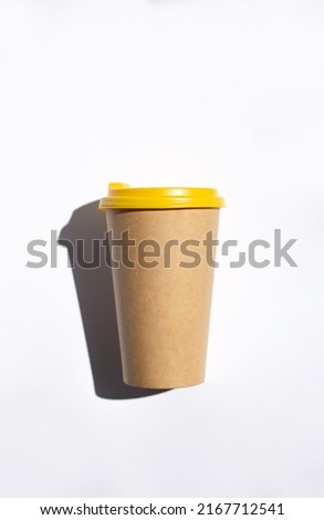 craft coffee cup with yellow cover top view, from above. Tea take away. Mock-up friendly