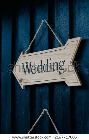 Wedding sign hanging on wooden wall