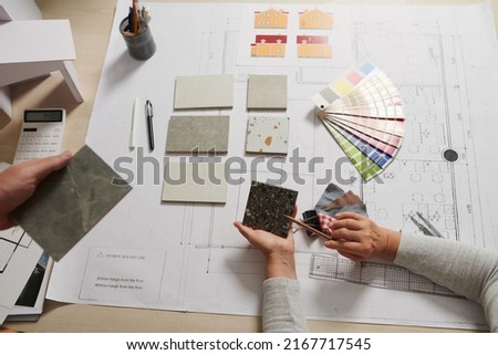 Architect and interior designer discussing floor tile and walls color for project Royalty-Free Stock Photo #2167717545