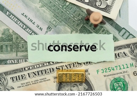 conserve.The word is written on a slip of paper,on colored background. professional terms of finance, business words, economic phrases. concept of economy.