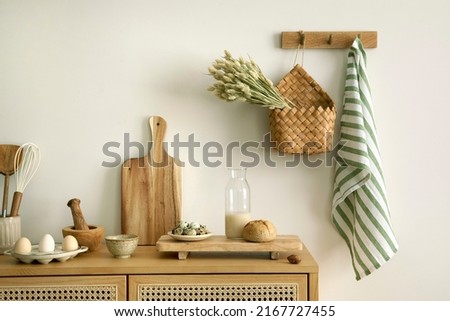 Interior design of kitchen space with rattan commode,  chair, herbs, vegetables, food and kitchen accessories in modern home decor. Template. 