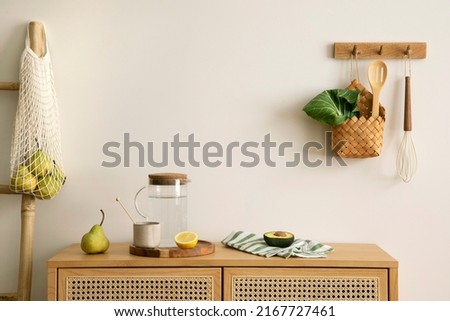 Interior design of kitchen space with rattan commode,  chair, herbs, vegetables, food and kitchen accessories in modern home decor. Template. 