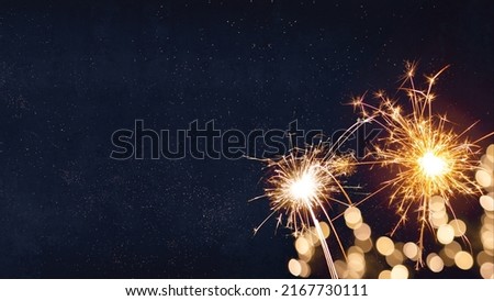 Silvester, New Year's Eve 2023 Party, New year, Fireworks, Firework holiday celebration background greeting card - Sparklers and bokeh lights on dark blue night sky Royalty-Free Stock Photo #2167730111