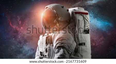 Astronaut in space. Galaxy and nebula space wallpaper. Spaceman sci-fi background. Elements of this image furnished by NASA Royalty-Free Stock Photo #2167731609