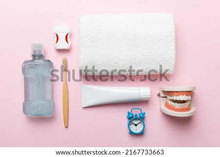 Mouthwash and other oral hygiene products on colored table top view with copy space. Flat lay. Dental hygiene. Oral care kit. Dentist concept. Royalty-Free Stock Photo #2167733663