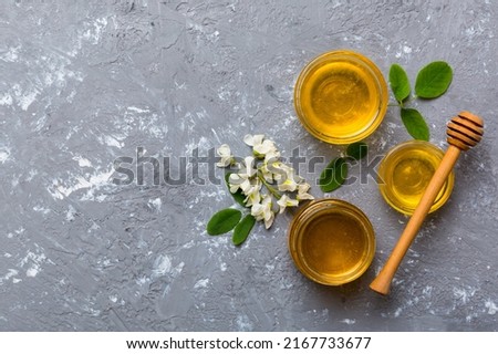 honey jar with acacia flowers and leaves. fresh honey top view flat lay.