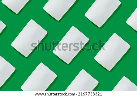 White cardboards packaging for tea, coffee, snack on green background. Blank tea packaging mockup to demonstrate your branding design. Pattern. 
