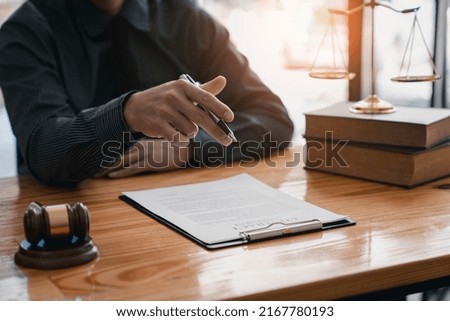 lawyer or judge is giving legal advice. to explaining about consultation terms and conditions to businessmen before signing on contract at a law firm.
