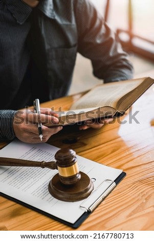 Attorney reading law code, studying constitution to protect human rights closeup, Male lawyer or judge working with Law books, gavel Royalty-Free Stock Photo #2167780713