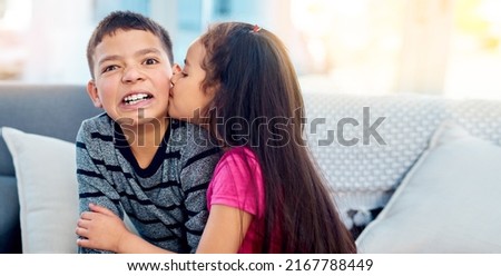 Yuck, girls are weird. Shot of an adorable little girl kissing her big brother on the cheek at home.