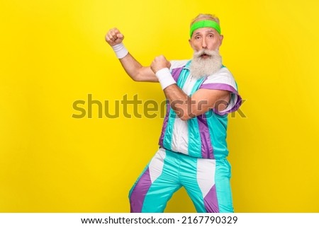 Profile photo of crazy aged person raise fists prepare fight enemy wear condensed milk tin color sport suit isolated on yellow background Royalty-Free Stock Photo #2167790329