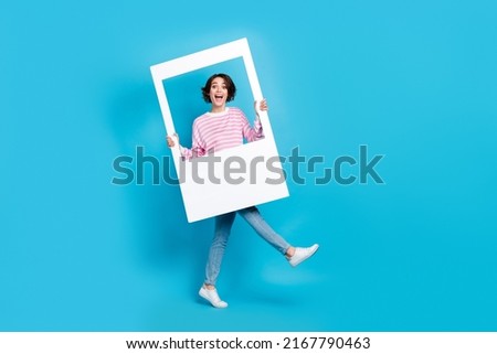 Full size photo of cheerful excited girl go on walk journey shooting memorable moments isolated on blue color background