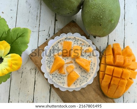 Mango milk cheese, milkcheese, fresh homemade served on a cup with jelly, selasih seed, and sweet mango topping Royalty-Free Stock Photo #2167801495
