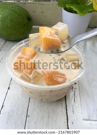 Mango Milk cheese fresh homemade with jelly, selasih seed and sweet mango inside cup ready to serve Royalty-Free Stock Photo #2167801907