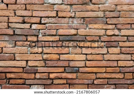 Close-up background of an old brick wall that has been renovated to be strong, often seen in old Thai temples.