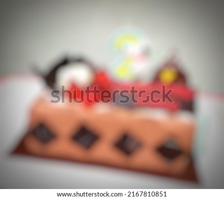Blurred bokeh image background of  birthday cake. Defocused party cake. 