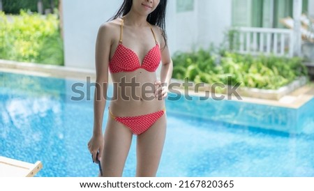 At the pool, Asian women are beauty. She had on a bikini.