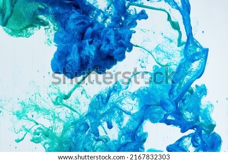 Creative dynamic abstract background with flowing splash of paint in water